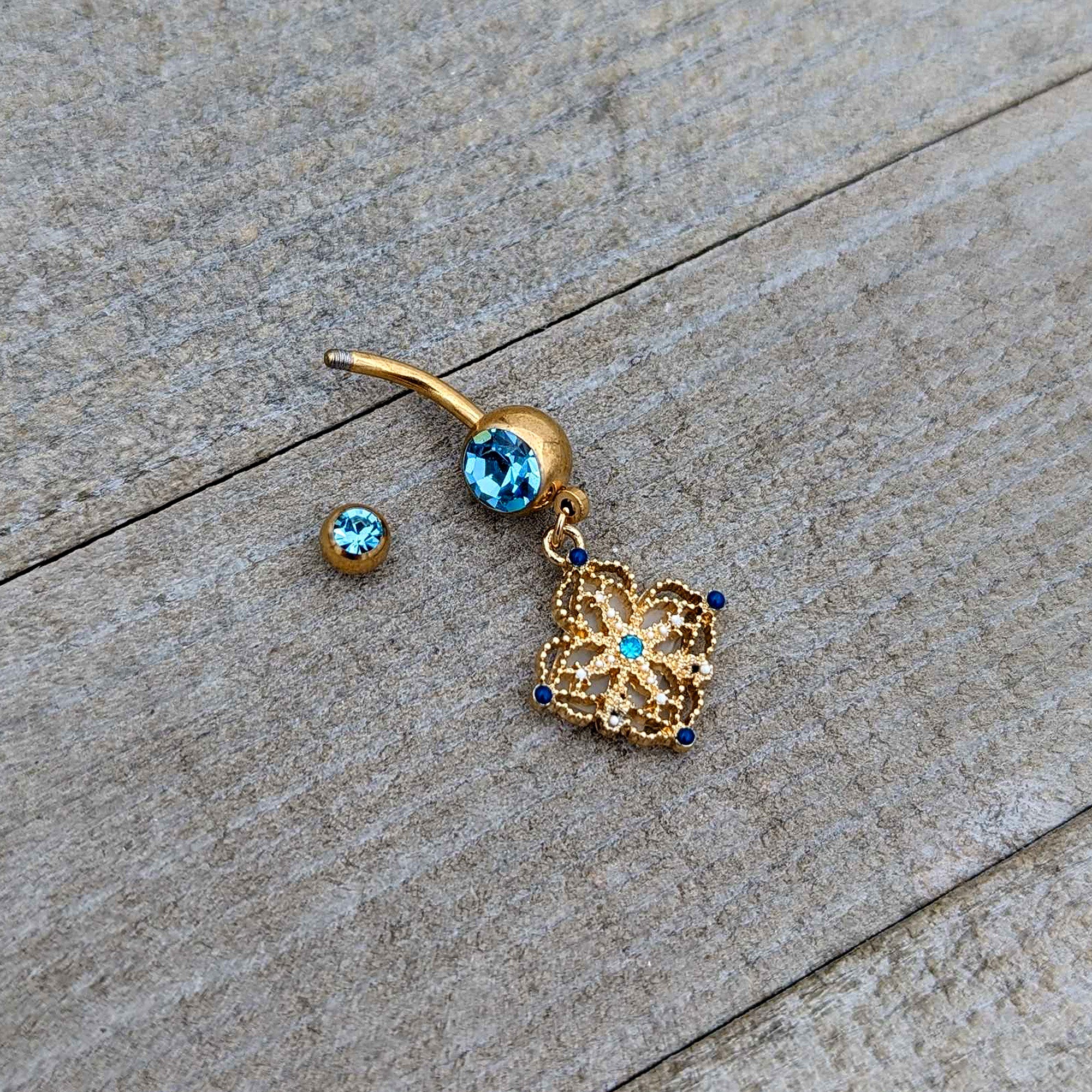 Blue Gem Gold Tone Texture Emblem Dangle Belly Ring